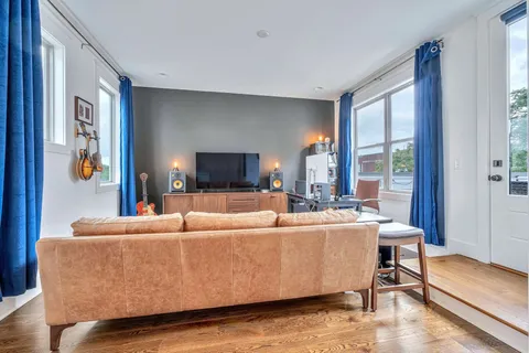 a living room with furniture and a flat screen tv
