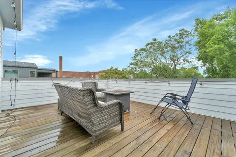 a view of a patio with wooden floor and outdoor seating