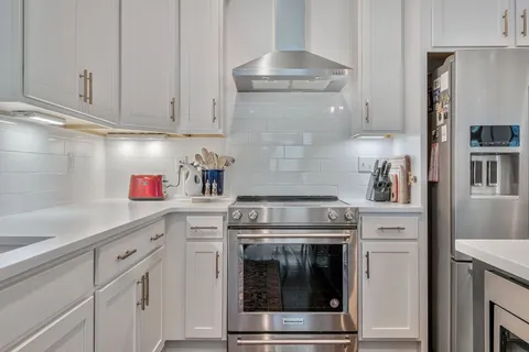 a kitchen with cabinets stainless steel appliances and wooden cabinets