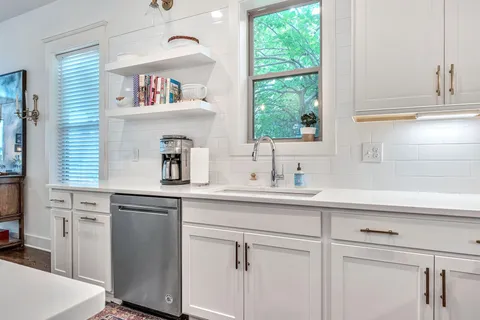 a kitchen with appliances cabinets and a window
