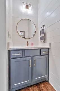 a kitchen with a sink a stove and a mirror