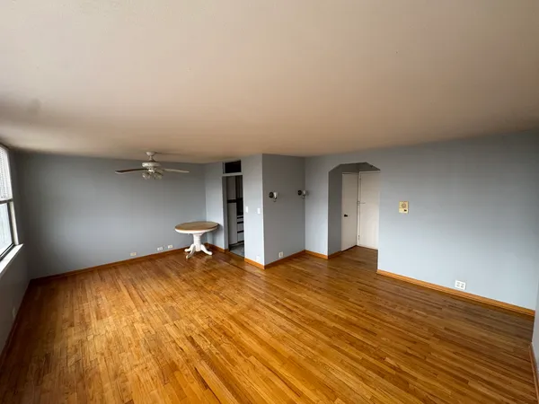 a view of empty room with wooden floor