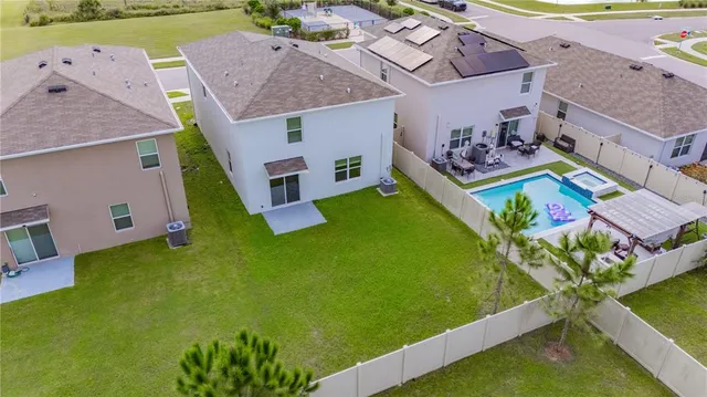 an aerial view of a house with pool