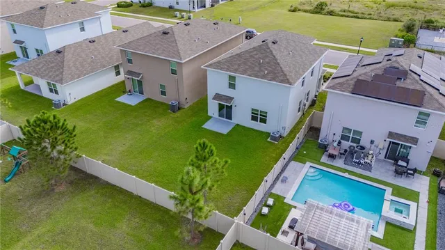 an aerial view of a house with swimming pool garden and patio