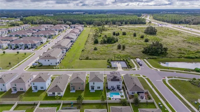 an aerial view of residential houses with outdoor space and swimming pool