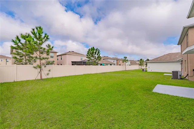 a view of kitchen with kitchen island white cabinets and stainless steel appliances