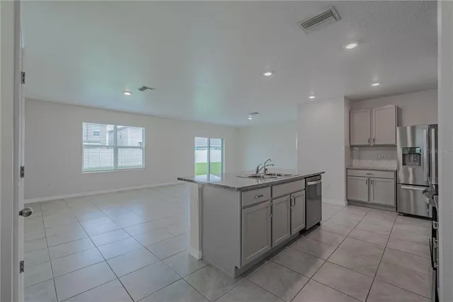 a view of a kitchen with a sink and a window