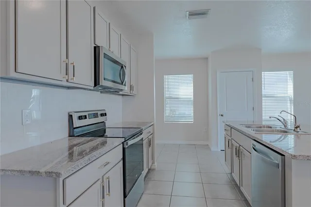 a bathroom with a toilet a sink a mirror a shower and vanity