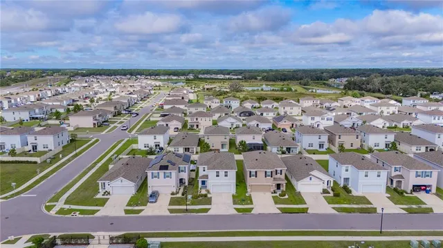 an aerial view of residential houses with outdoor space