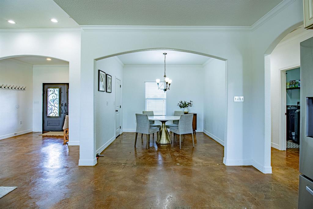 328 Meadow Lane Red Oak, TX 75154 - Photo 9 of 35 Dining space featuring arched walkways, healthy amount of natural light, ornamental molding, finished concrete floors, and recessed lighting