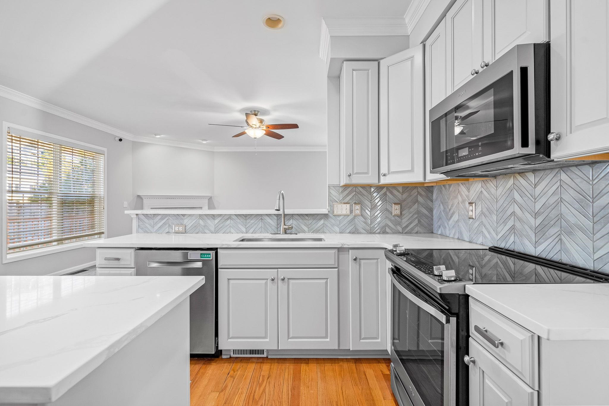 113 Whitney Lane Durham, NC 27713 - Photo 15 of 34 a kitchen with a sink stove and microwave