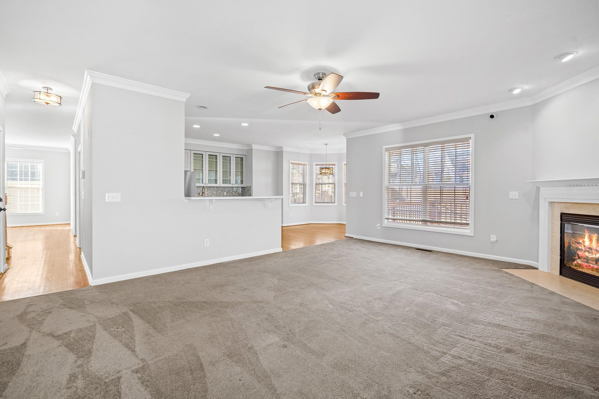 113 Whitney Lane Durham, NC 27713 - Photo 22 of 34 a view of an empty room with a window and a kitchen