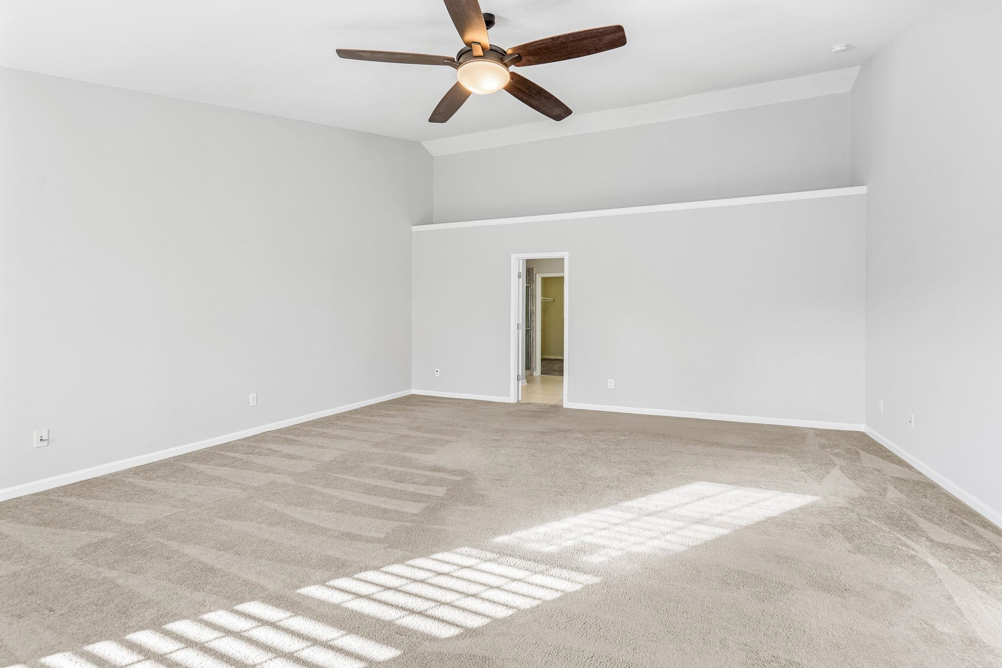 113 Whitney Lane Durham, NC 27713 - Photo 24 of 34 an empty room with chandelier fan and windows