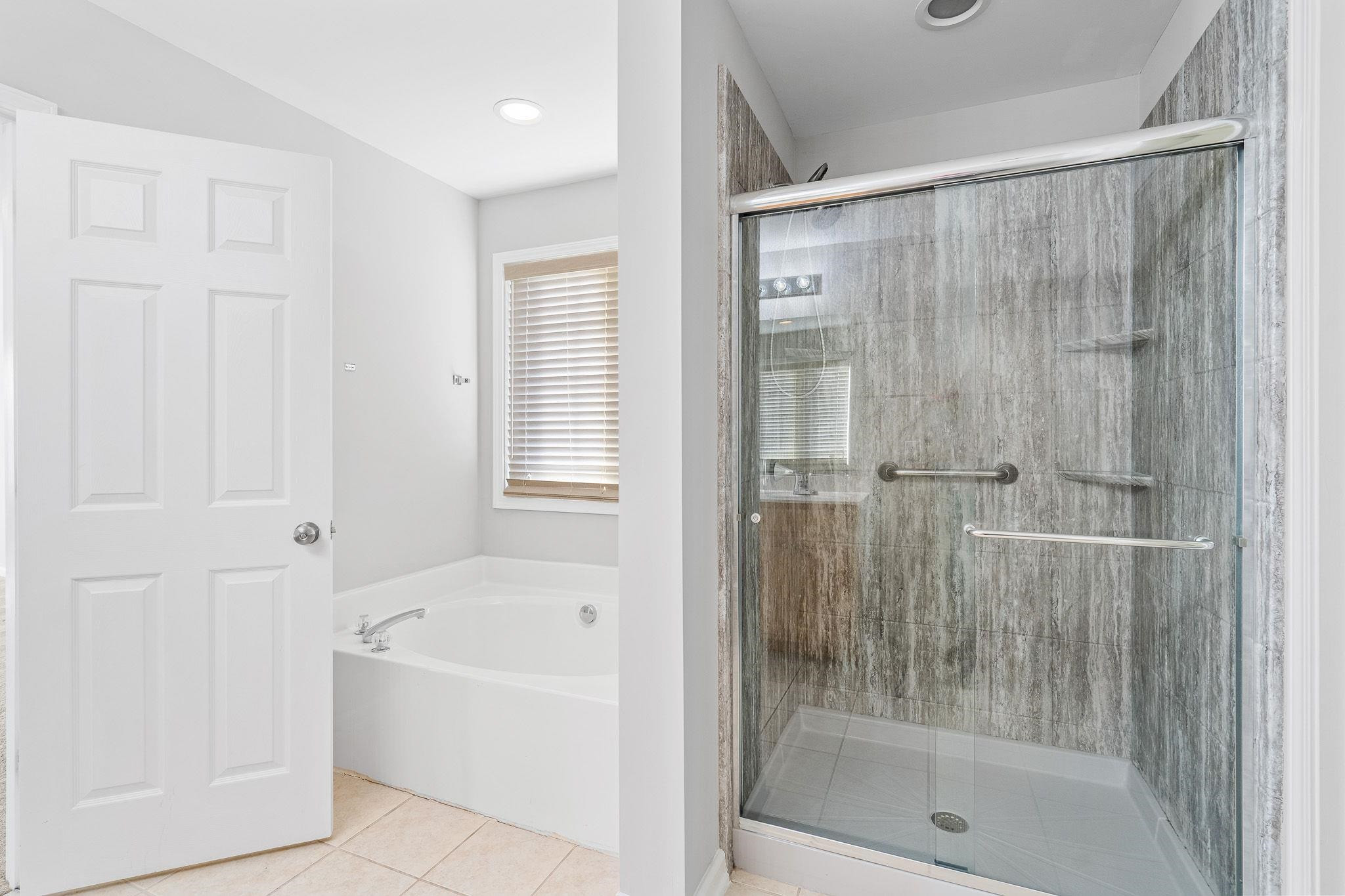 113 Whitney Lane Durham, NC 27713 - Photo 26 of 34 a bathroom with a bathtub and shower