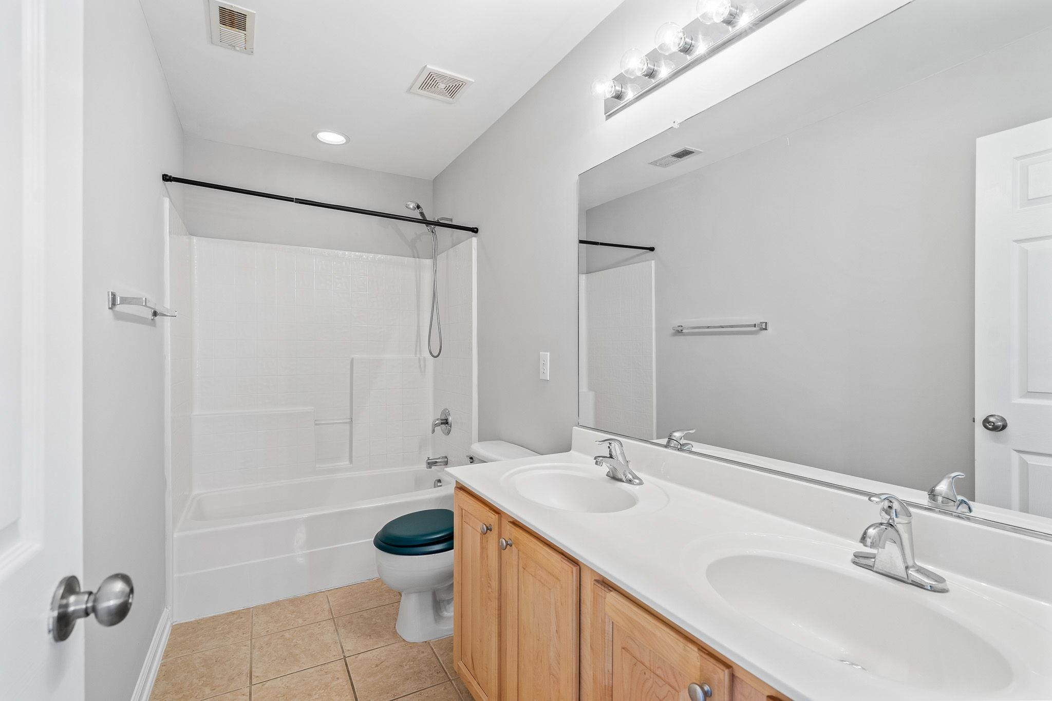 113 Whitney Lane Durham, NC 27713 - Photo 29 of 34 a bathroom with a sink toilet a mirror and shower