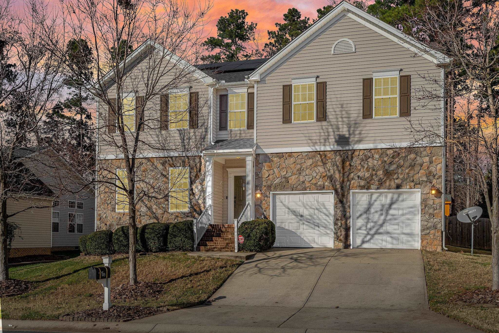 113 Whitney Lane Durham, NC 27713 - Photo 6 of 34 a front view of a house with a yard and garage