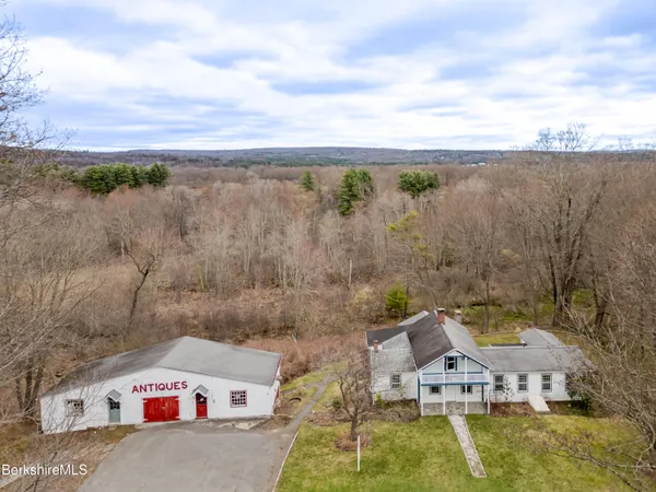an aerial view of a house with a garden and lake view