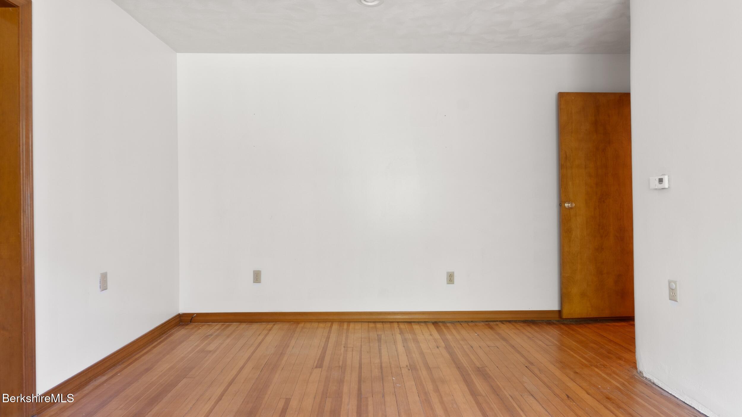 20 East Dugway Road Lenox, MA 01240 - Photo 30 of 84 a view of an empty room with wooden floor and a window