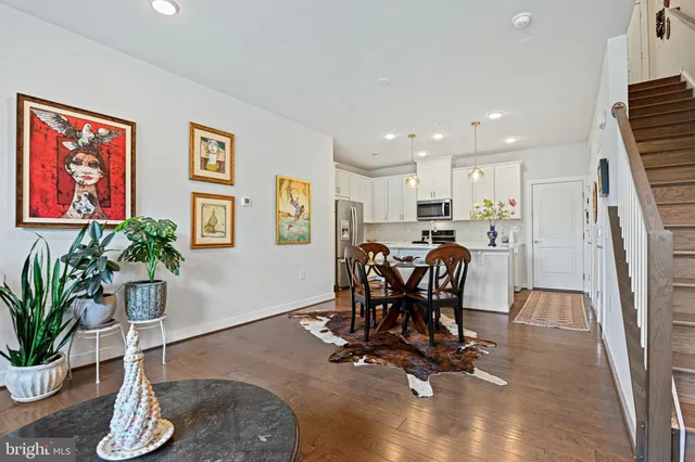 a dining room with furniture and potted plant