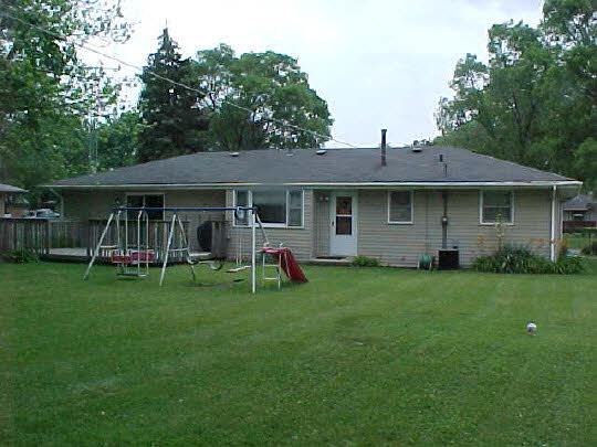 7142 Ralph Road Rockford, IL 61109 - Photo 2 of 2 a view of a house with a yard and sitting area