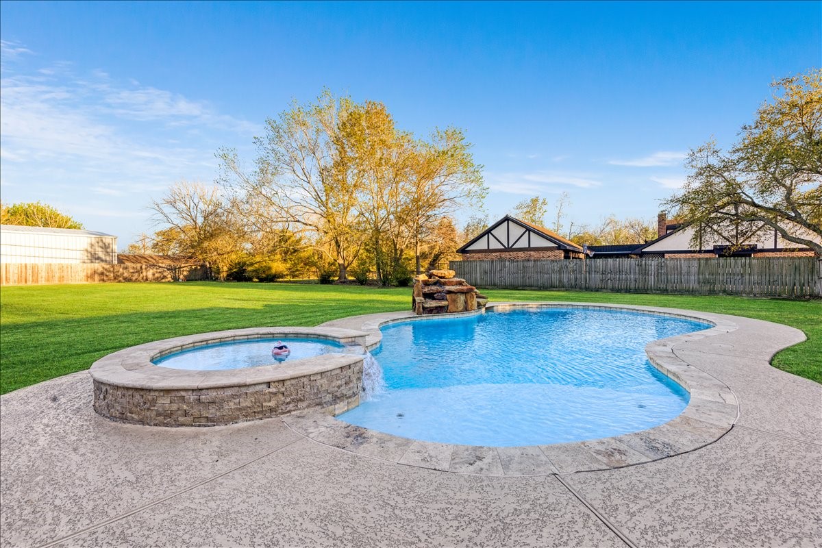 3809 Wingtail Way Pearland, TX 77584 - Photo 20 of 29 a view of a house with swimming pool and a yard