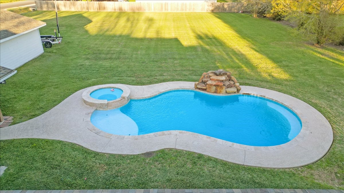 3809 Wingtail Way Pearland, TX 77584 - Photo 24 of 29 a view of a swimming pool with a yard