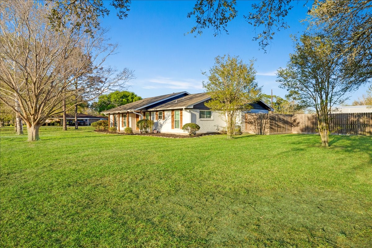 3809 Wingtail Way Pearland, TX 77584 - Photo 3 of 29 a view of a white house with a big yard and large trees