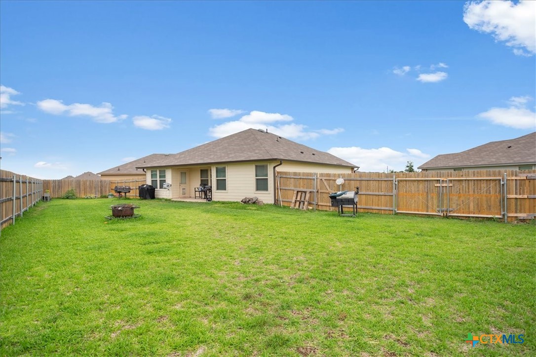 1000 Velvet Court Troy, TX 76579 - Photo 23 of 25 a front view of a house with a garden and yard