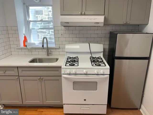 a kitchen with a stove and a refrigerator