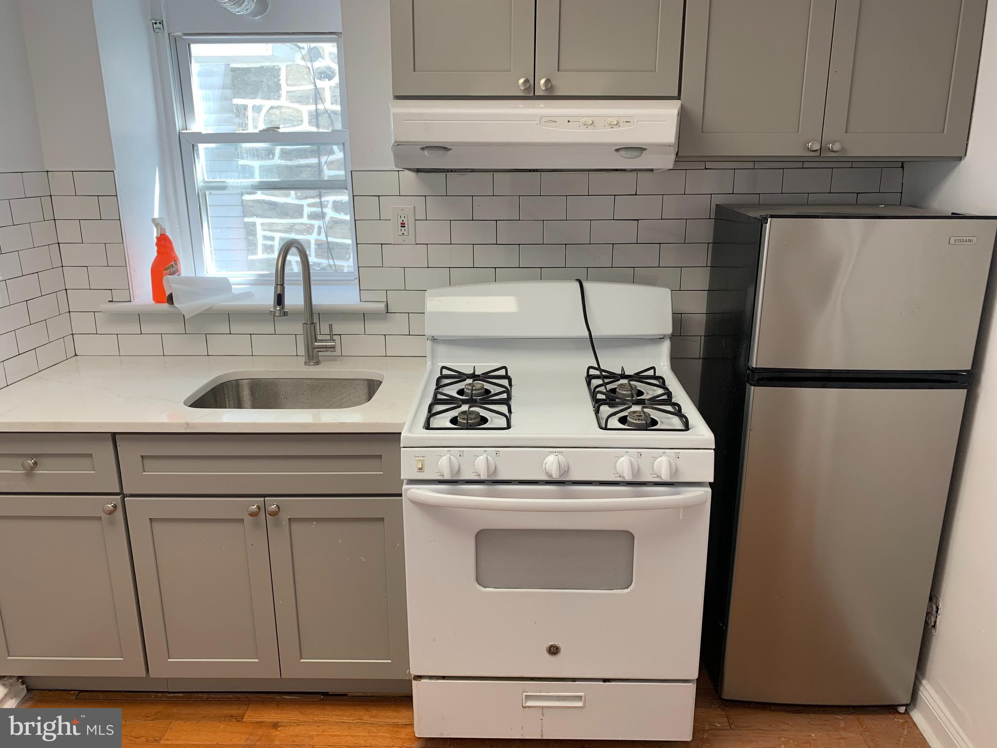 8 Overhill Road, Unit A Upper Darby, PA 19082 - Photo 5 of 6 a kitchen with a stove and a refrigerator