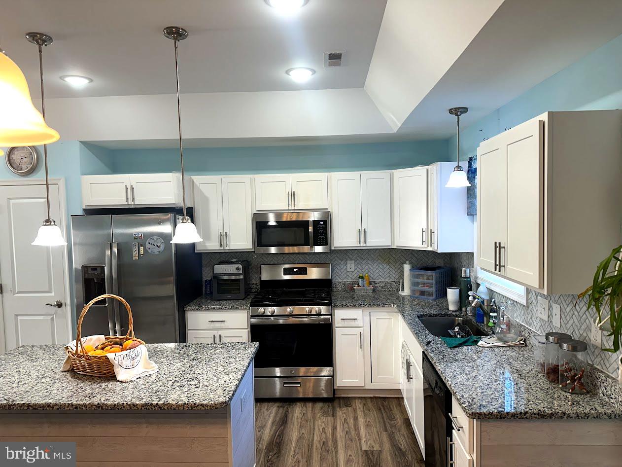 24266 Fox Run Seaford, DE 19973 - Photo 3 of 50 a kitchen with stainless steel appliances granite countertop a sink refrigerator and microwave