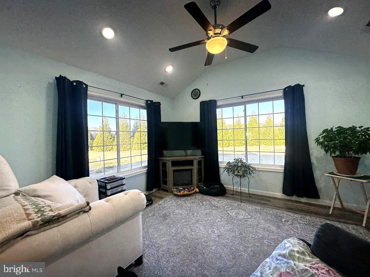 24266 Fox Run Seaford, DE 19973 - Photo 4 of 50 a living room with furniture a window and a flat screen tv
