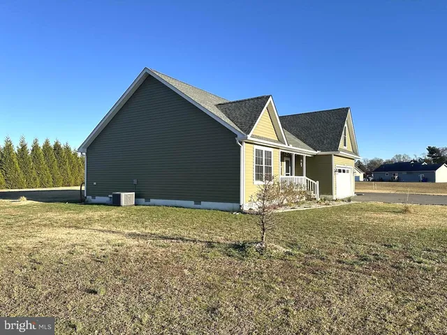a front view of a house with a parking space