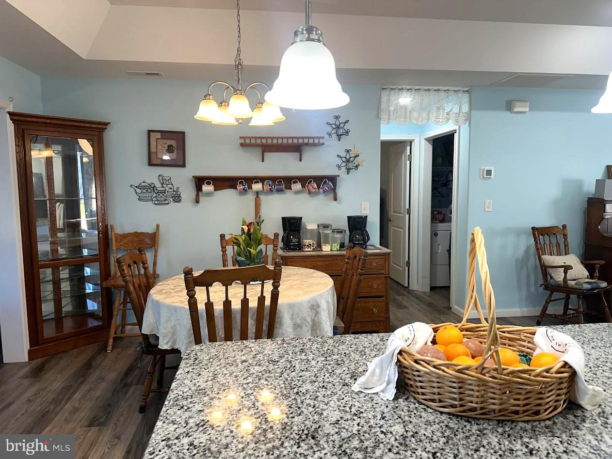 24266 Fox Run Seaford, DE 19973 - Photo 9 of 50 a living room with furniture a chandelier and a dining table