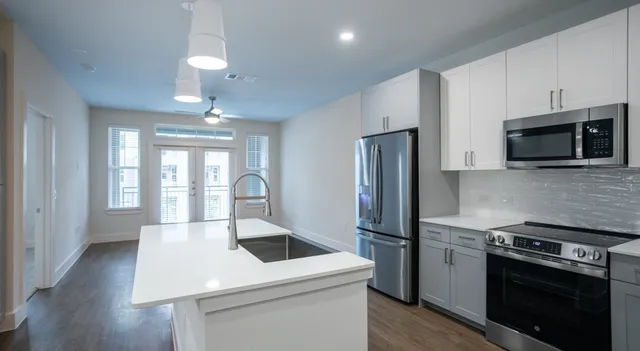 a bedroom with a bed and cabinets