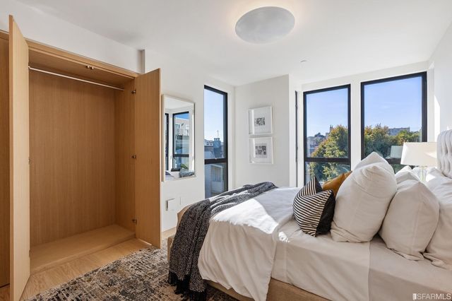 a bedroom with a bed and glass door