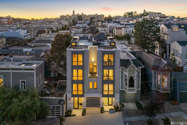 a front view of a residential apartment building with a yard