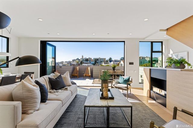 a living room with furniture and a floor to ceiling window