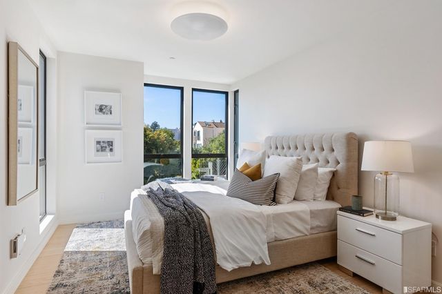 a bedroom with a bed and a lamp