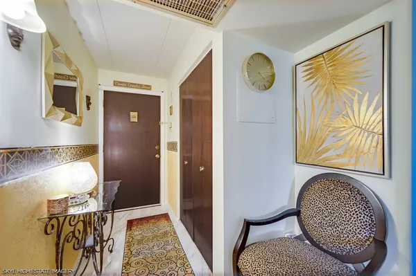 a view of a hallway with wooden floor and door