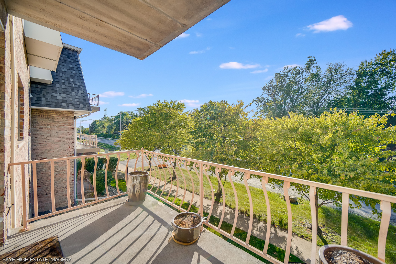 18855 Burnham Avenue, Unit 234 Lansing, IL 60438 - Photo 7 of 19 a view of a balcony with wooden floor and fence