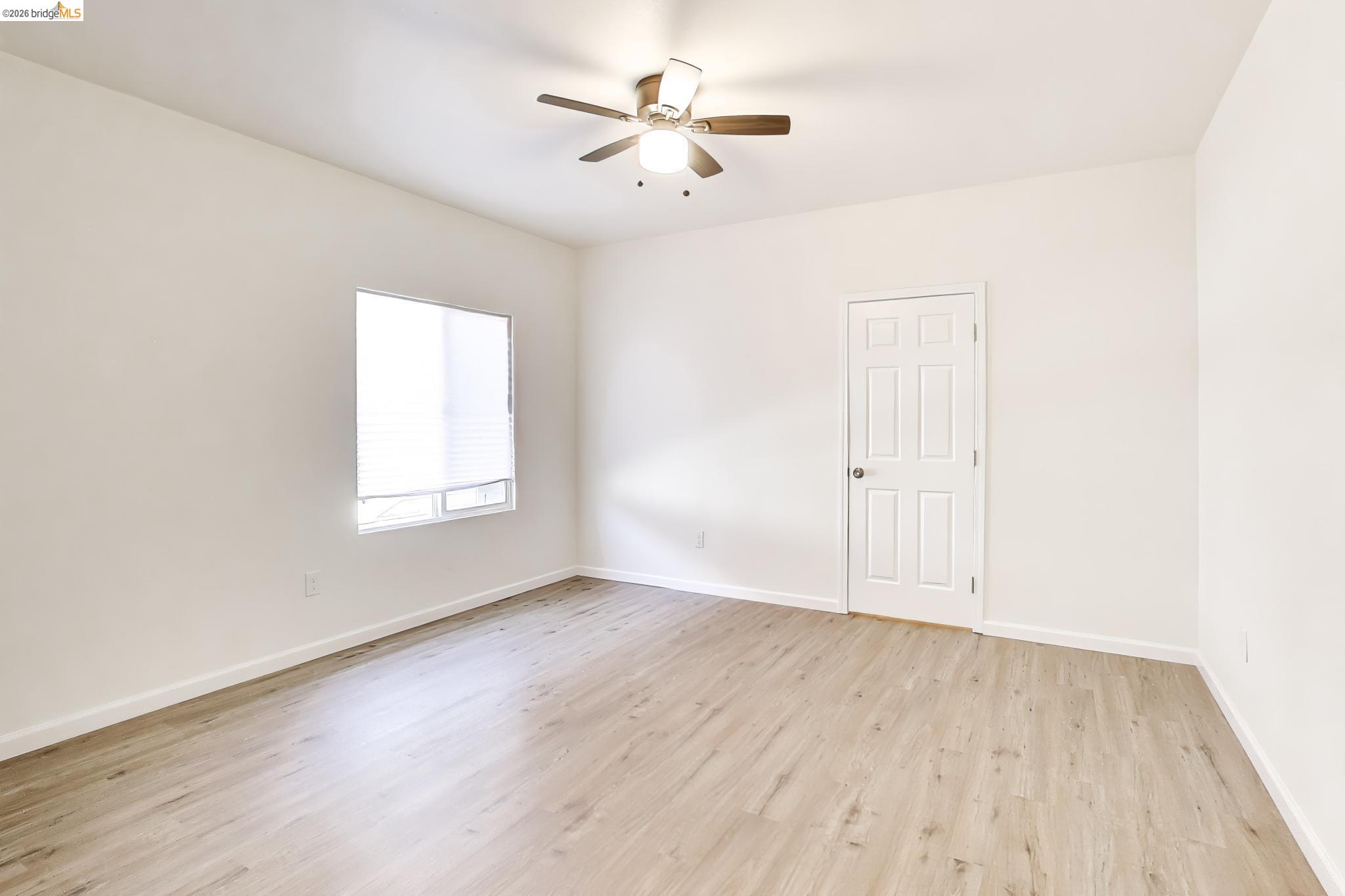 1978 Rosedale Avenue Oakland, CA 94601 - Photo 20 of 36 an empty room with wooden floor and windows