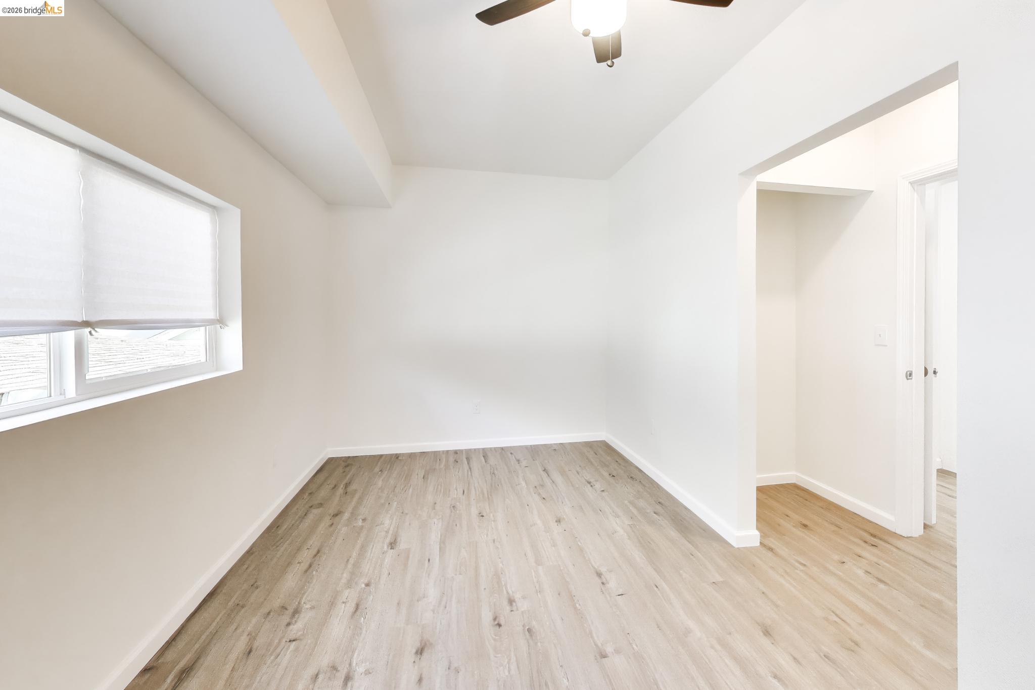 1978 Rosedale Avenue Oakland, CA 94601 - Photo 25 of 36 an empty room with wooden floor cabinet and windows