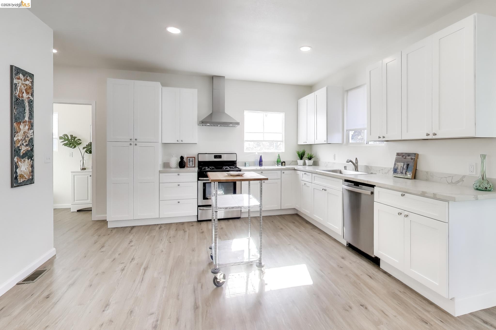 1978 Rosedale Avenue Oakland, CA 94601 - Photo 7 of 36 a kitchen with cabinets stainless steel appliances a sink and a window
