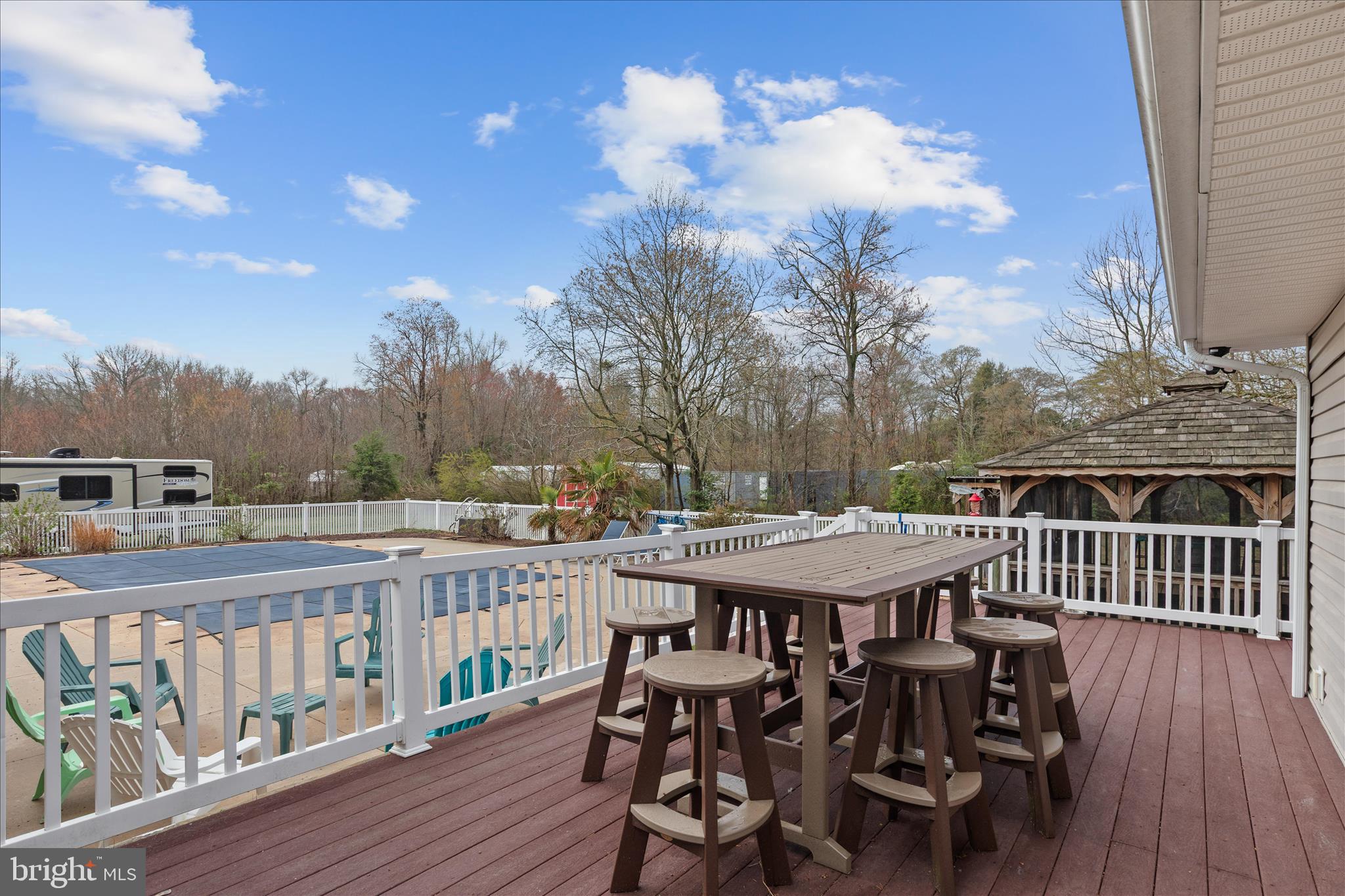 12647 Old Stage Road Bishopville, MD 21813 - Photo 81 of 84 a view of a roof deck with table and chairs a barbeque with wooden floor and fence