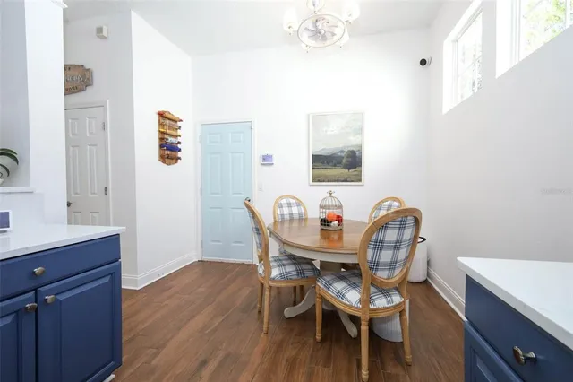 a dining room with furniture and wooden floor