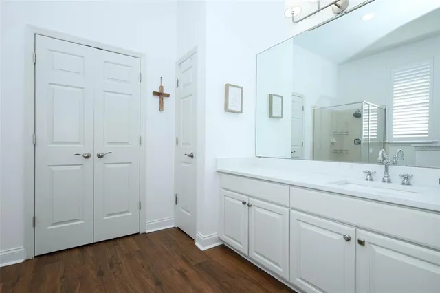 a bathroom with a double vanity sink and mirror