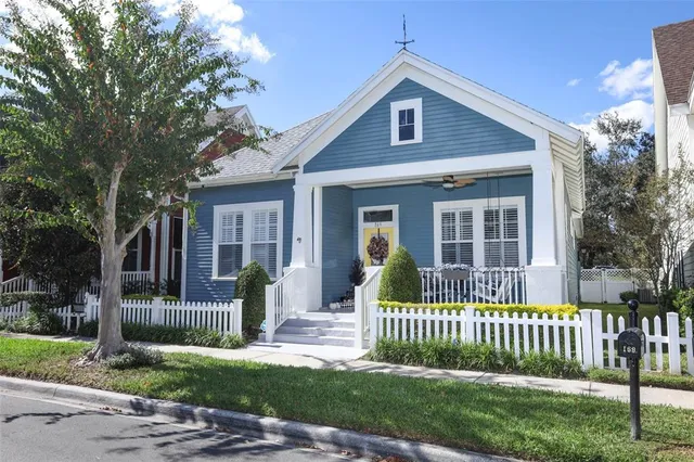 a front view of a house with a garden and plants