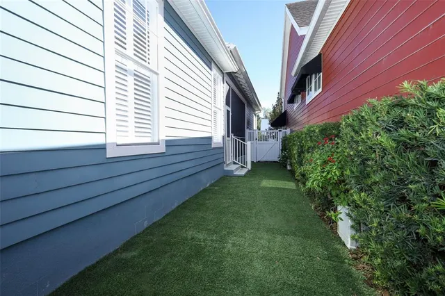 a view of backyard with potted plants and wooden walls