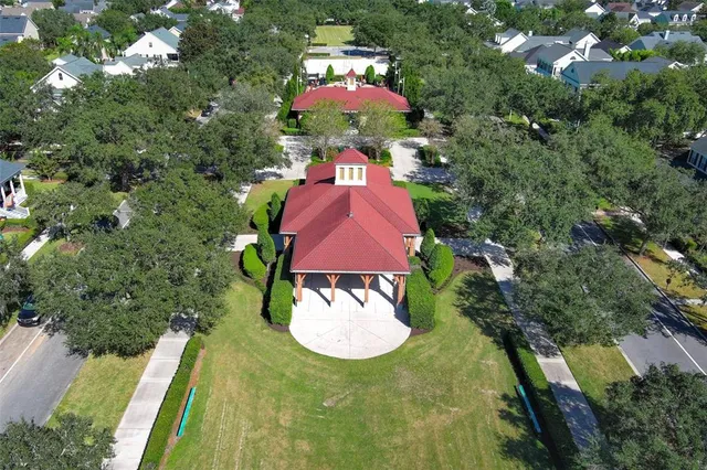 an aerial view of residential houses with outdoor space and swimming pool